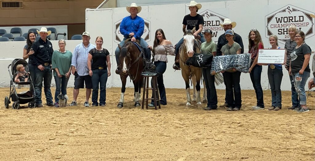 A Woman Holds a Check While a Group of People Stand around a Horse.
