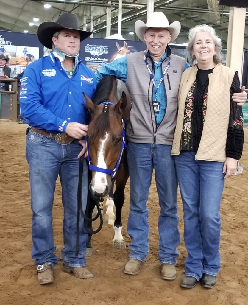 Three People and a Horse in an Arena.